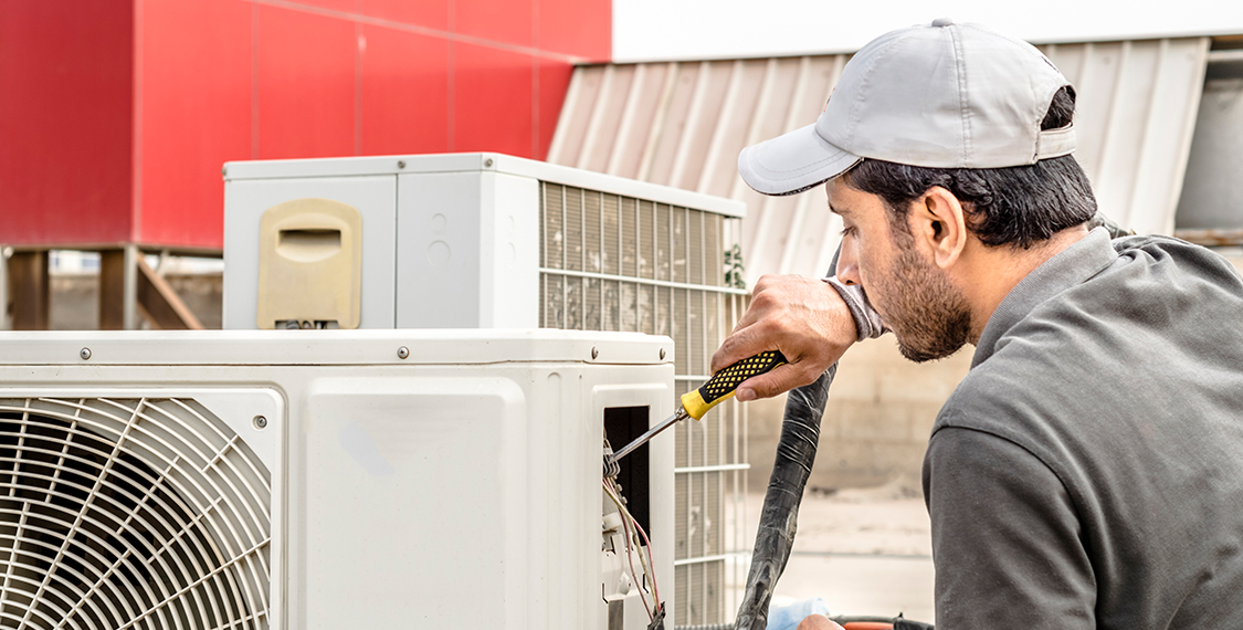 Technician repairing an HVAC unit