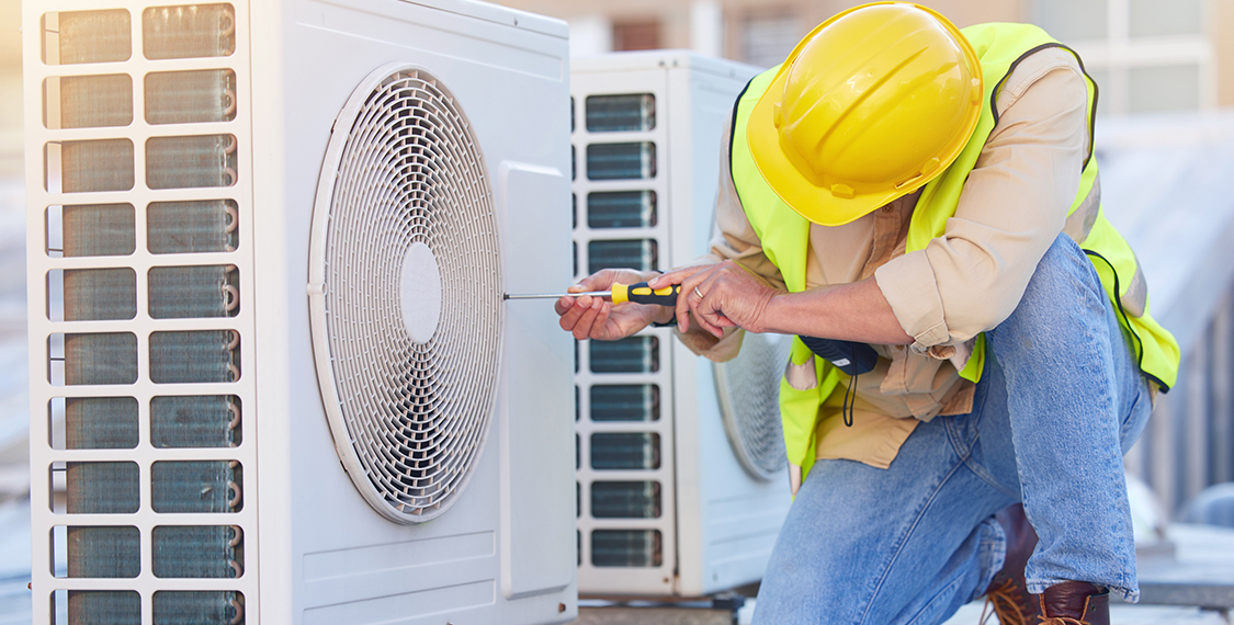 Technician reapring a HVAC unit